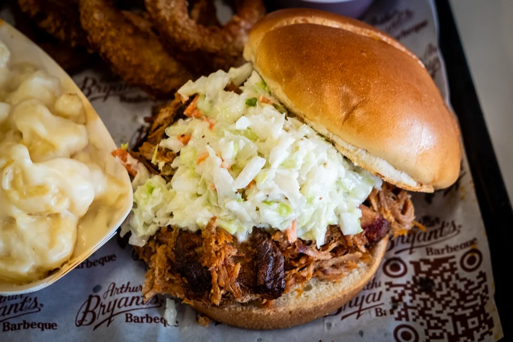 Pulled pork topped with coleslaw on a toasted bun